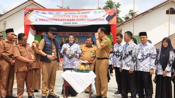 Pemotongan tumpeng oleh PJ Bupati Tebo dan Kadis Kominfo Provinsi Jambi dalam rangka JOB Fair dan Peringatan Hari Guru ke 79 Di SMKN 1 Tebo